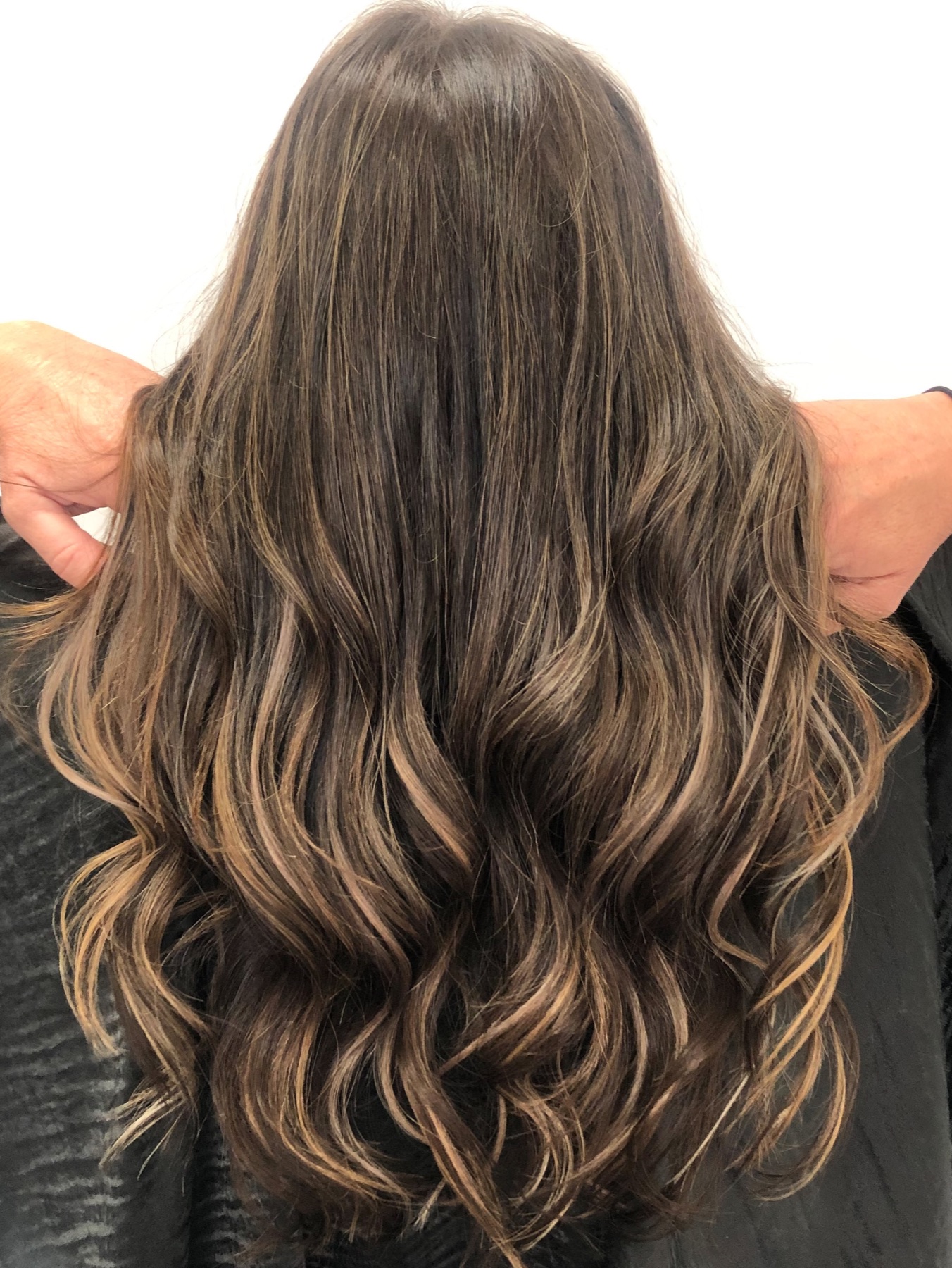 Long brunette waves with soft caramel dimension